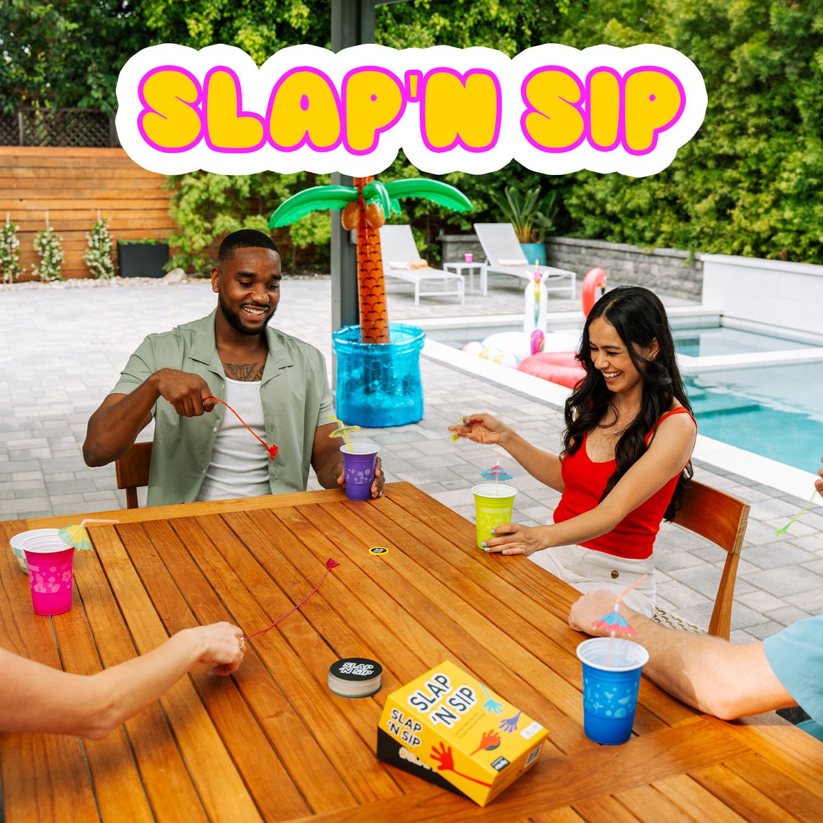 Two players reaching for the Sip Chip with sticky hands at a poolside table