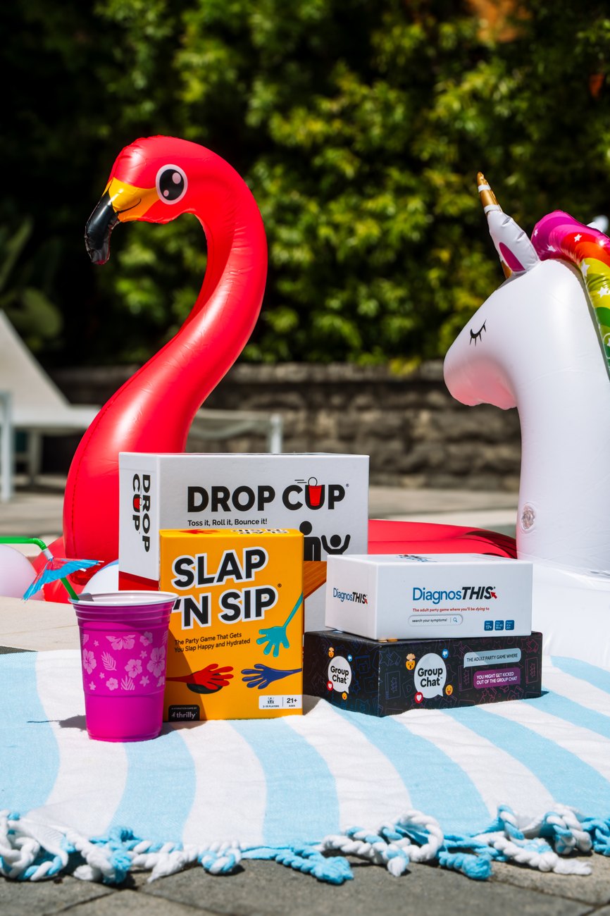 A poolside game night scene with Thrilly boxes on the table